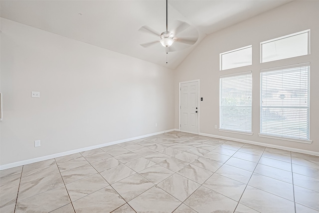 empty room featuring ceiling fan, lofted ceiling, and light tile patterned floors