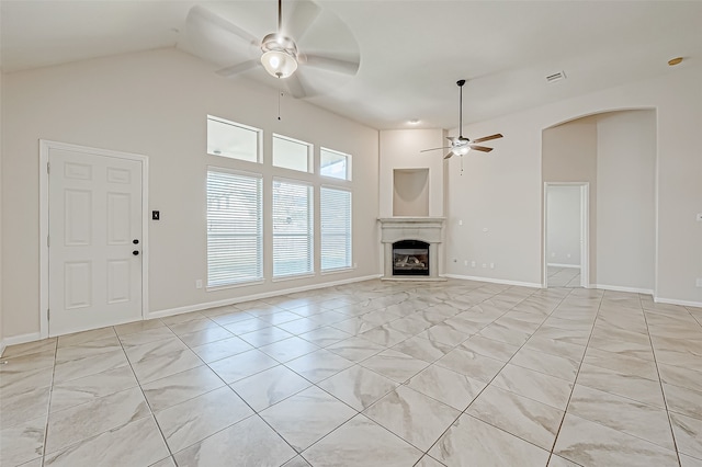 unfurnished living room with ceiling fan and vaulted ceiling