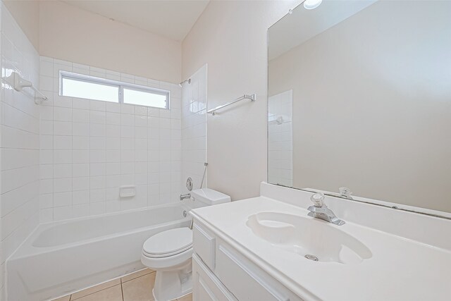 full bathroom featuring tile patterned flooring, vanity, tiled shower / bath combo, and toilet