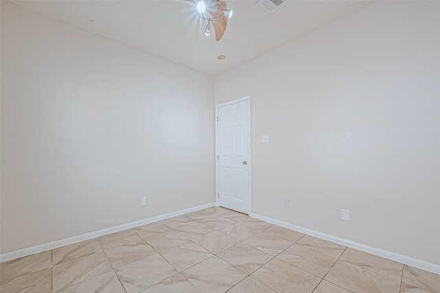 tiled empty room featuring vaulted ceiling