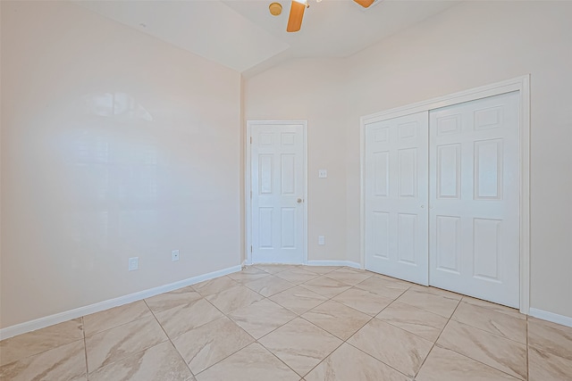 unfurnished bedroom with ceiling fan, a closet, and vaulted ceiling