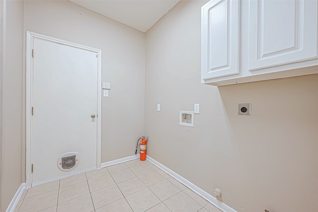 laundry area with cabinets, washer hookup, hookup for an electric dryer, gas dryer hookup, and light tile patterned flooring