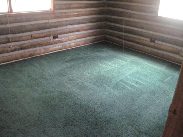 unfurnished room featuring dark carpet