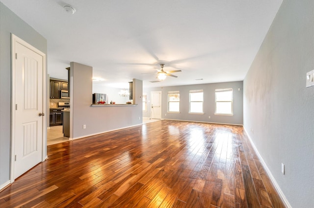 unfurnished living room with wood-type flooring and ceiling fan