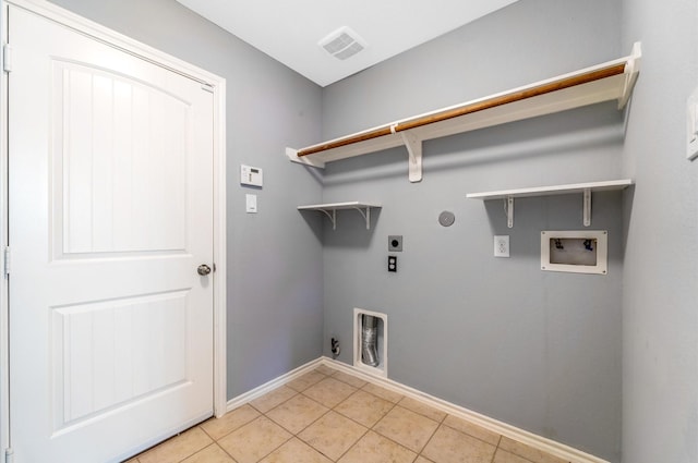 laundry area featuring electric dryer hookup, hookup for a gas dryer, light tile patterned floors, and washer hookup