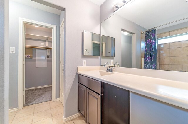 bathroom with a shower with curtain, tile patterned flooring, and vanity