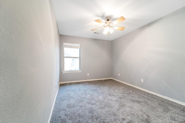 carpeted spare room featuring ceiling fan