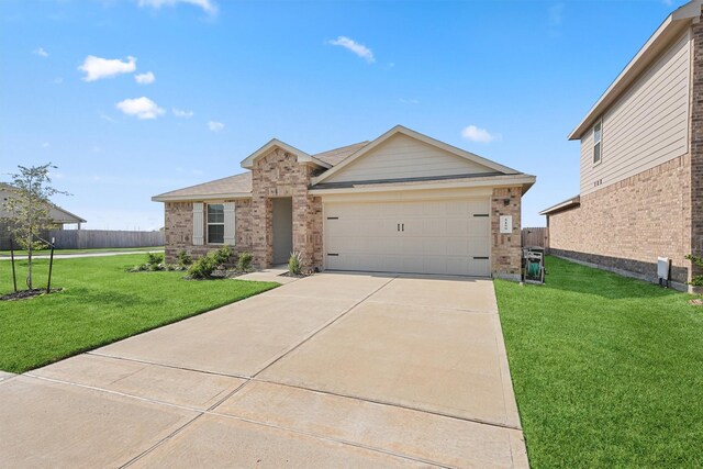 view of front of house featuring a garage and a front lawn