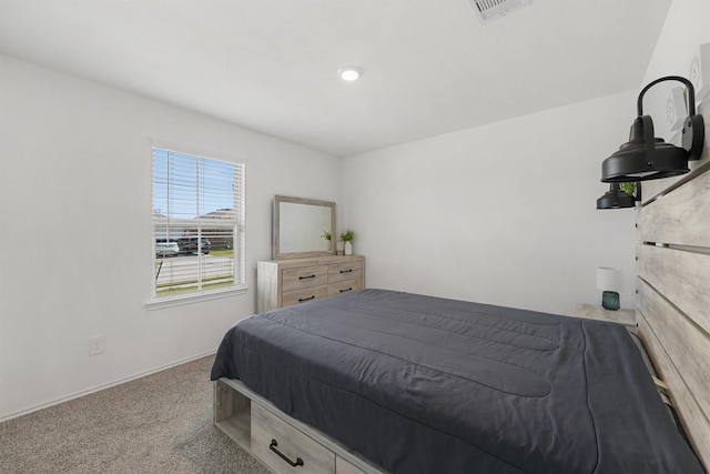 carpeted bedroom featuring visible vents