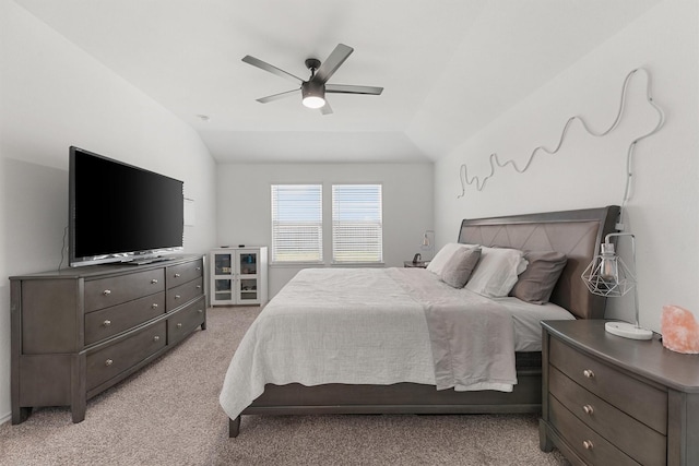 bedroom with lofted ceiling, ceiling fan, and light colored carpet