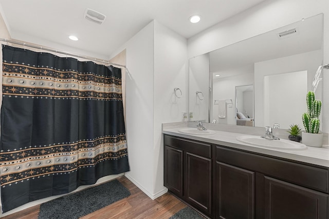 bathroom with wood-type flooring and vanity