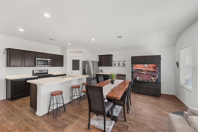 dining space with baseboards, visible vents, wood finished floors, and recessed lighting