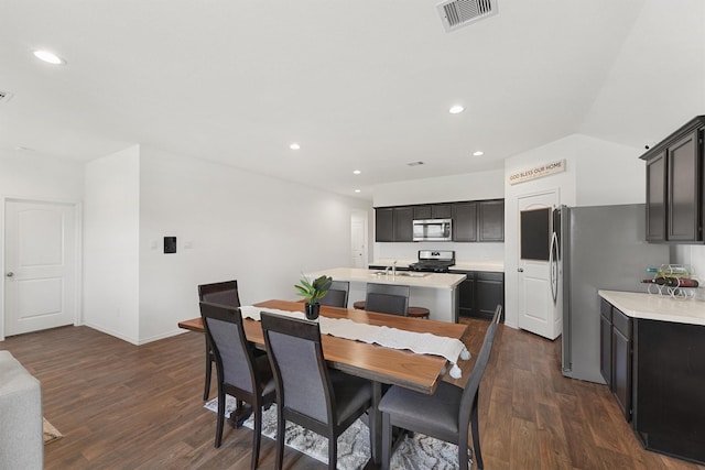 dining area featuring dark wood-style floors, recessed lighting, visible vents, and vaulted ceiling