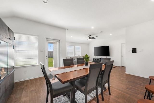 dining space with ceiling fan, vaulted ceiling, and dark hardwood / wood-style floors