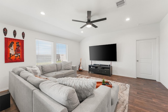 living room featuring ceiling fan, vaulted ceiling, and dark wood-type flooring