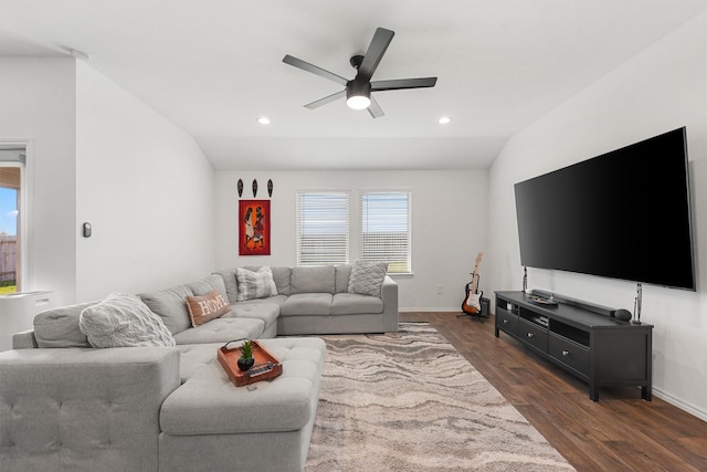 living room with ceiling fan, dark wood-type flooring, and lofted ceiling