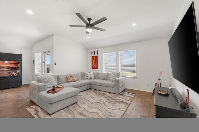 living room with lofted ceiling, ceiling fan, and dark wood-type flooring