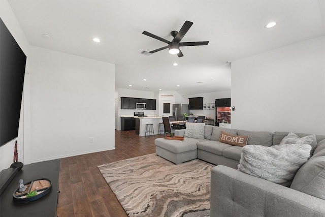 living area with baseboards, visible vents, ceiling fan, dark wood-type flooring, and recessed lighting