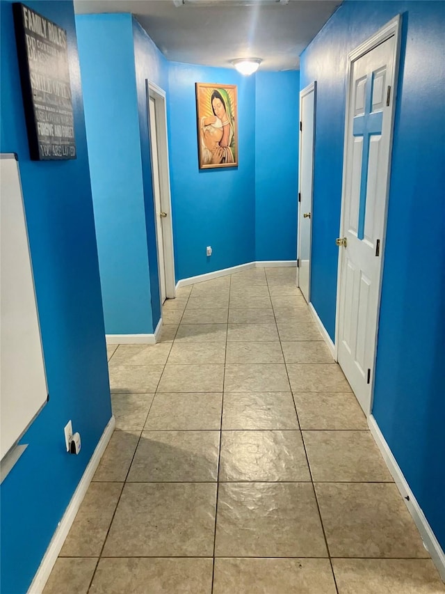 hall with light tile patterned floors