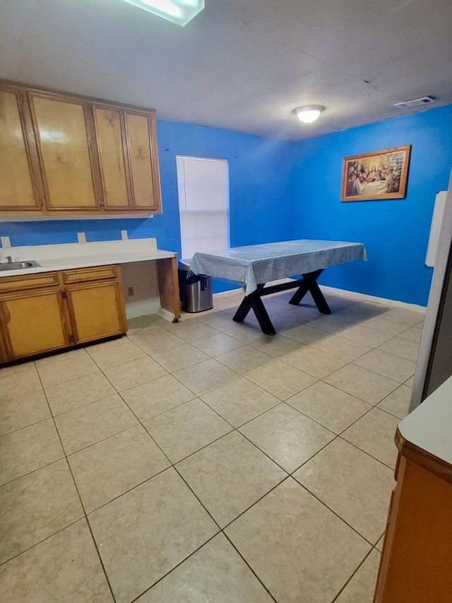 kitchen featuring sink and light tile patterned floors