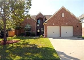 view of front property with a garage and a front yard