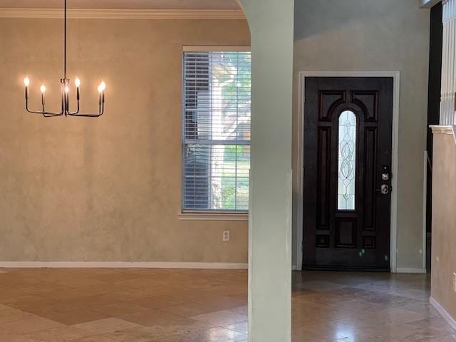 entrance foyer featuring an inviting chandelier and ornamental molding