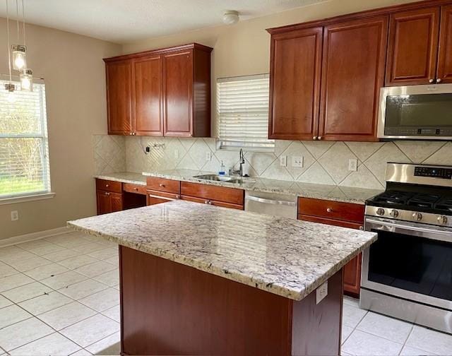 kitchen with appliances with stainless steel finishes, backsplash, decorative light fixtures, and sink