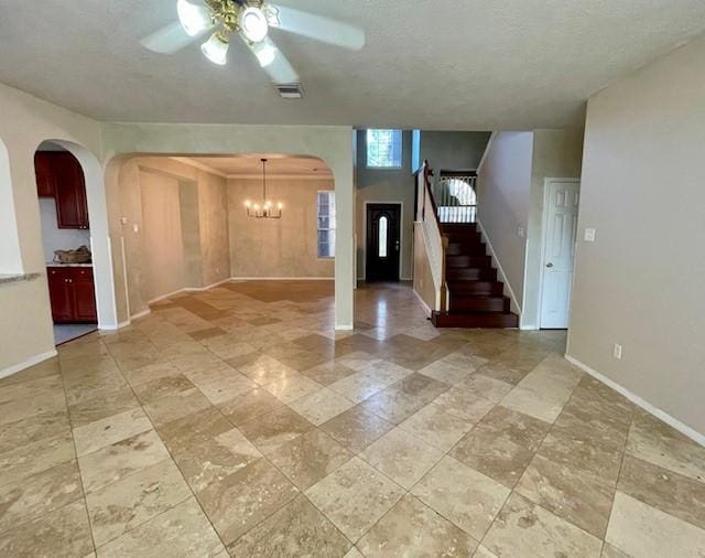 entryway featuring ceiling fan with notable chandelier