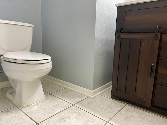 bathroom with tile patterned flooring and toilet