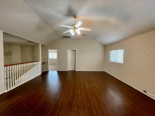 spare room featuring ceiling fan, a healthy amount of sunlight, and dark hardwood / wood-style floors