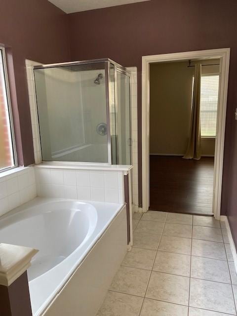 bathroom with plus walk in shower and hardwood / wood-style flooring