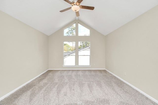 carpeted empty room featuring ceiling fan and vaulted ceiling