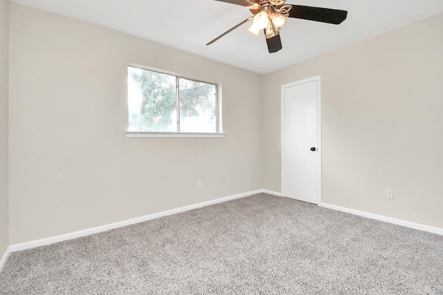 carpeted spare room featuring ceiling fan