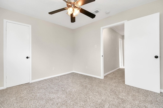 unfurnished room with ceiling fan and light carpet