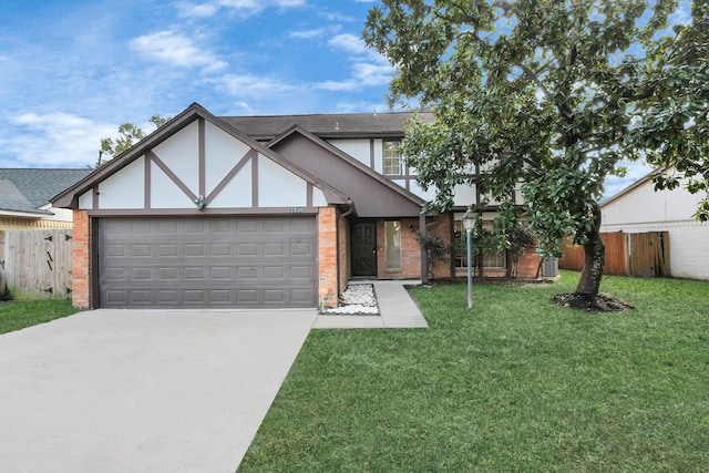 english style home with a garage and a front lawn