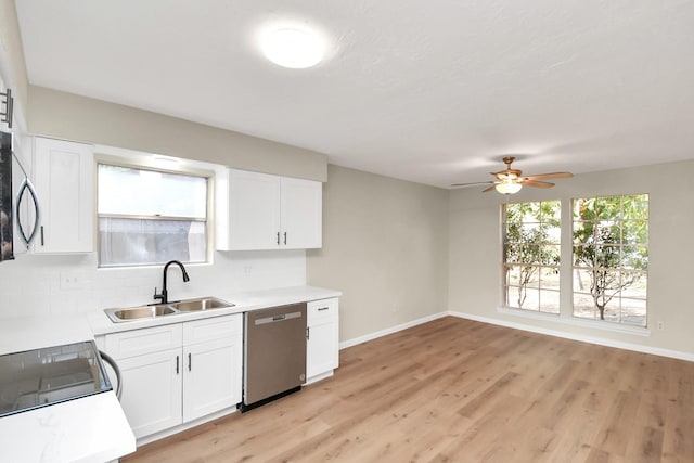 kitchen with light wood-type flooring, stainless steel appliances, ceiling fan, sink, and white cabinetry