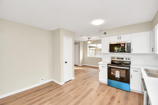 kitchen featuring white cabinetry, ceiling fan, stainless steel appliances, and light wood-type flooring