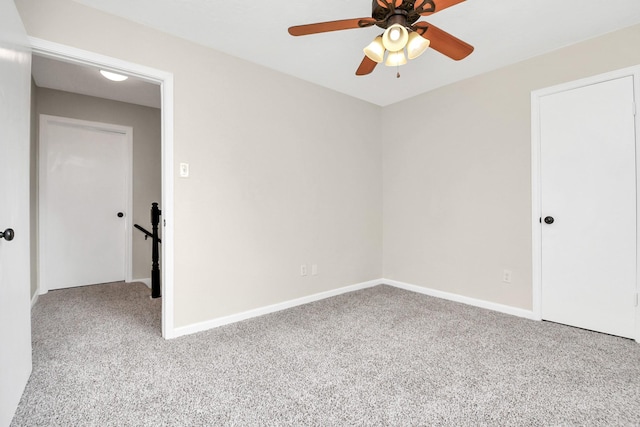 spare room featuring light colored carpet and ceiling fan