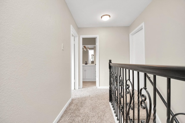 hallway featuring light carpet