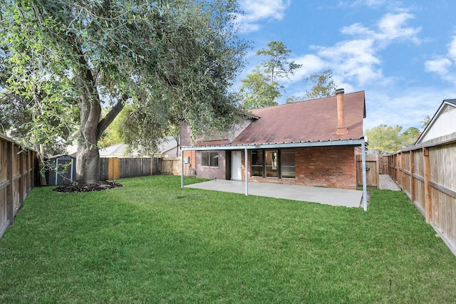 back of property featuring a storage unit, a lawn, and a patio area