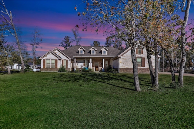 new england style home with a lawn