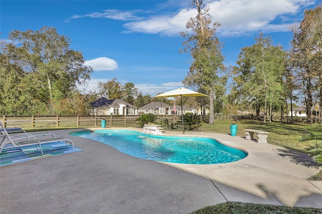 view of pool with pool water feature, a patio area, and a yard