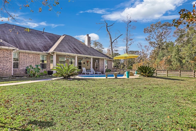 view of yard with a fenced in pool and a patio area