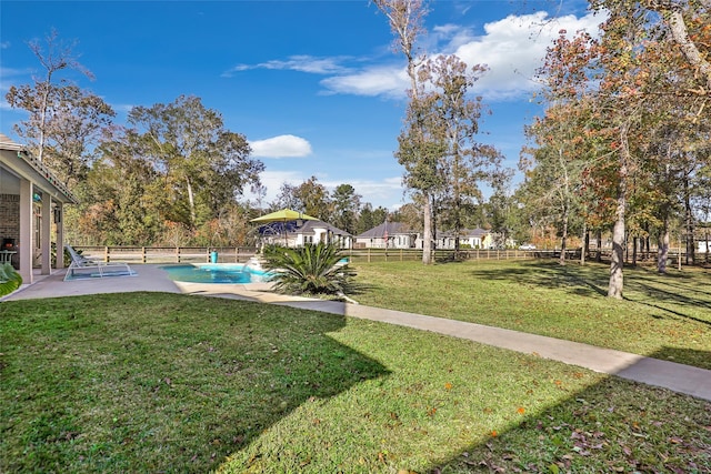 view of yard with a patio area and a fenced in pool