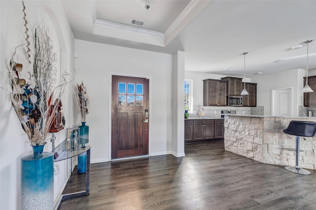 entryway with a tray ceiling and dark hardwood / wood-style flooring