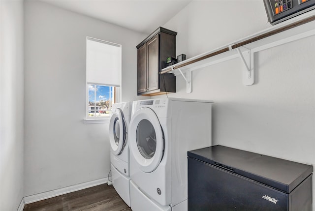 washroom with cabinets, dark hardwood / wood-style floors, and washing machine and dryer