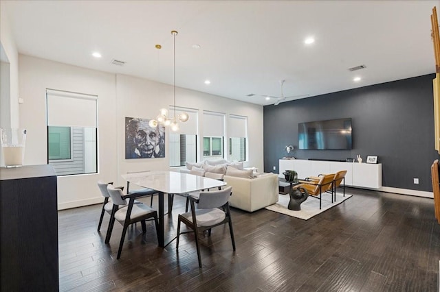 dining room with dark wood-type flooring and a chandelier