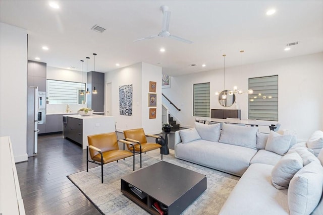 living room with ceiling fan and hardwood / wood-style floors