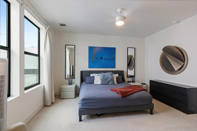 bedroom featuring light carpet