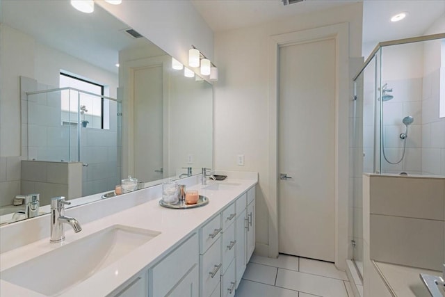 bathroom with tile patterned flooring, vanity, and a shower with shower door